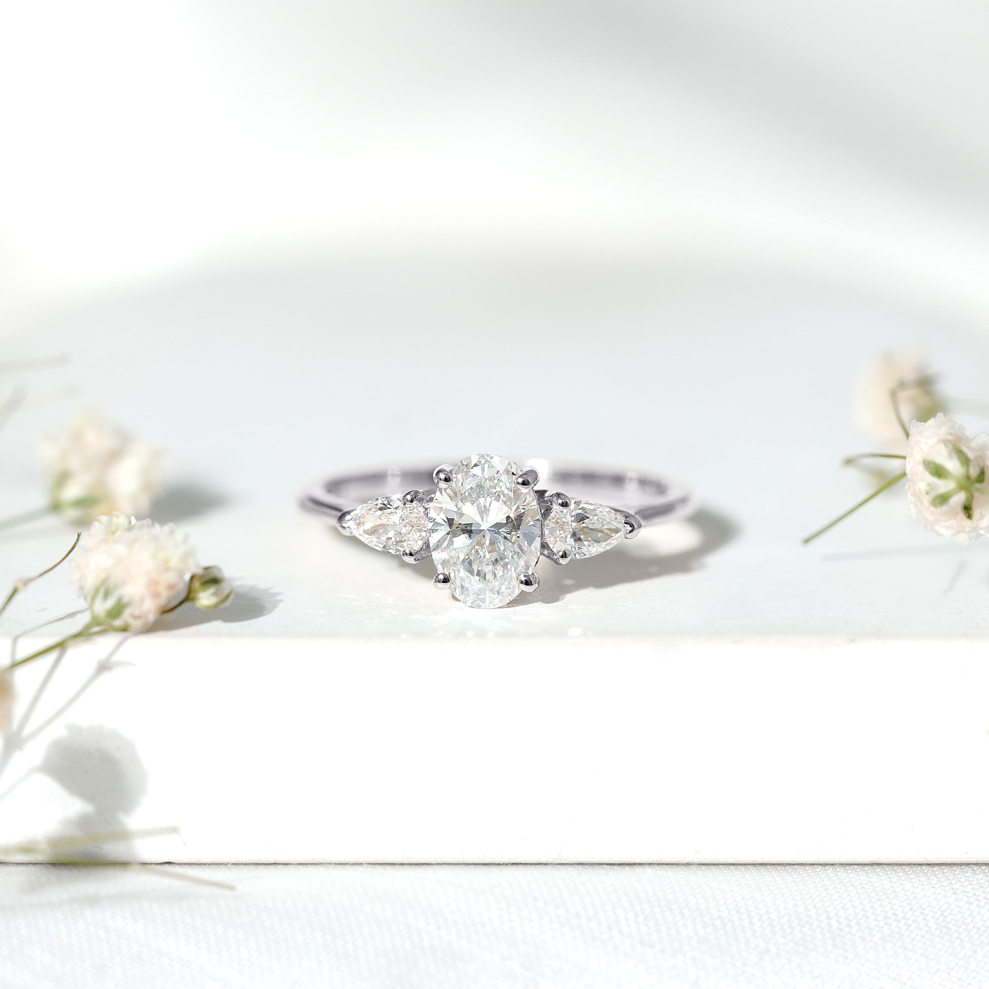 Rosec Jewels-Oval and Pear Cut Moissanite Three Stone Engagement Ring